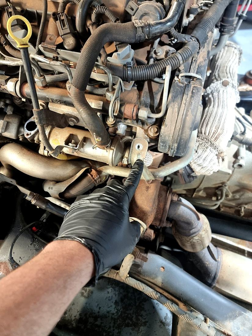 Mobile mechanic hands-on diagnostic repair work under the bonnet